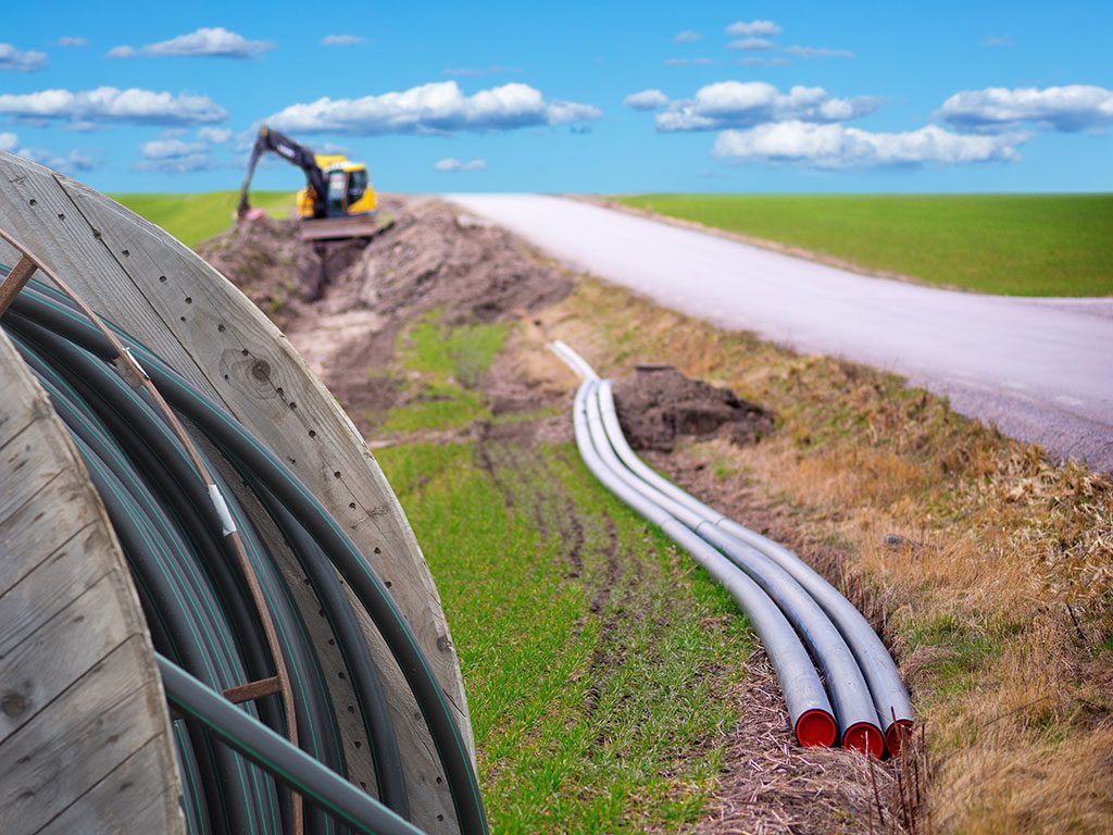 Workers installing cable to bring broadband access to rural communities.