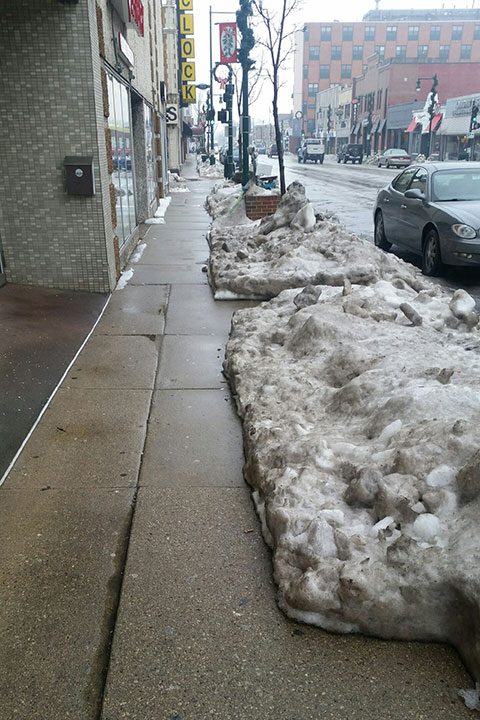 Clearing sidewalks of snow in West Allis, WI
