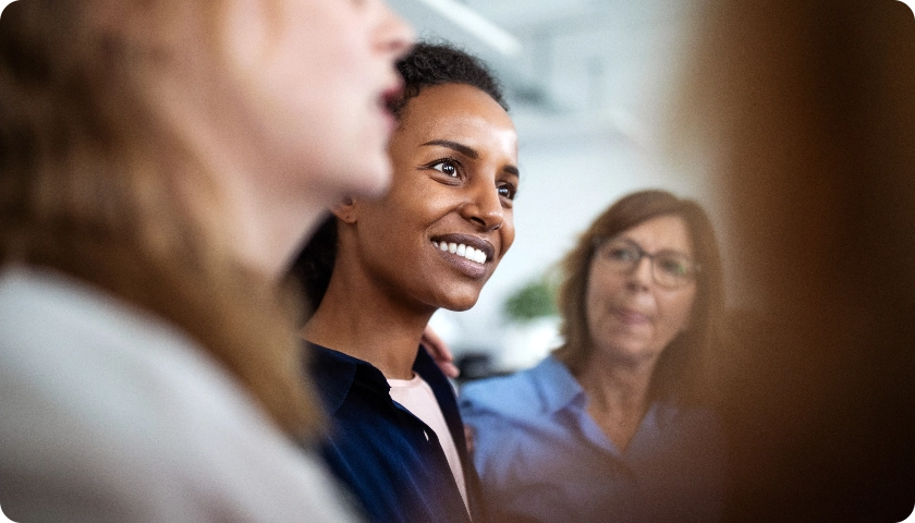 Smiling woman in a group of other women.