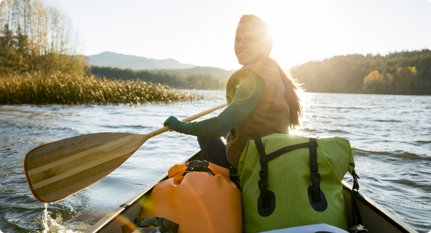 A woman kayaking down a river.