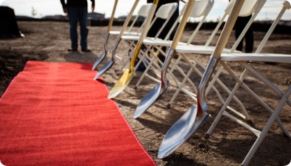A line of shovels ready for a groundbreaking ceremony.