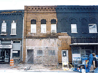 Removing black paint from historic downtown buildings.