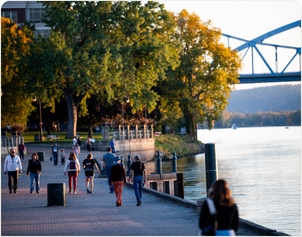 Folks strolling along a waterfront path 