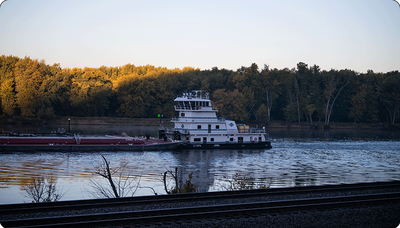 Photo shows a barge traveling down the Mississippi River.
