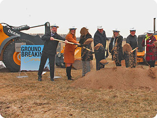 A line of shovels ready for a groundbreaking ceremony.