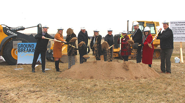 Image of people shoveling sand at ground breaking ceremony