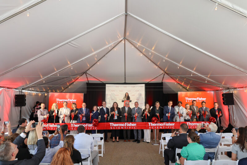 Group posing for photo during ribbon cutting event celebrating expansion of Thermo Fisher Scientific in Middleton, Wisconsin.