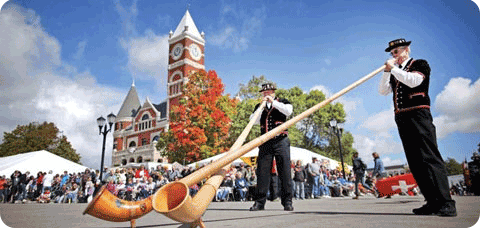 Image of two men playing Alphorns at Monroe festival