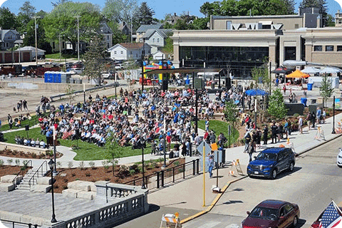Image of people sitting in town square for outdoor event in Watertown