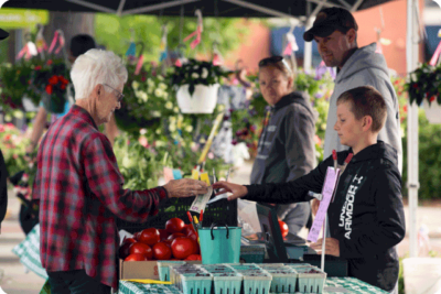 Image of woman purchasing fresh produce at Fond du Lac farmers market