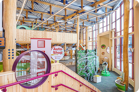 Image of Children’s Museum of Eau Claire, a two-story structure that uses exposed whole-tree columns and round-timber joists.