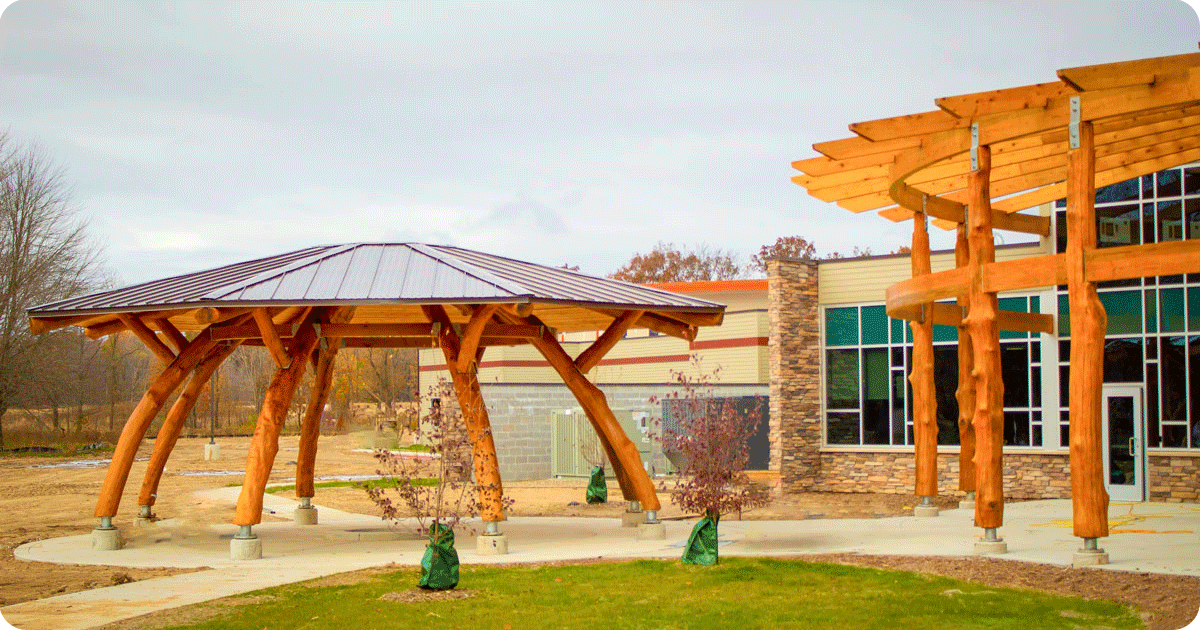 Image of a pergola and a pavilion made with naturally bent trees. Photo courtesy of WholeTrees Structures.