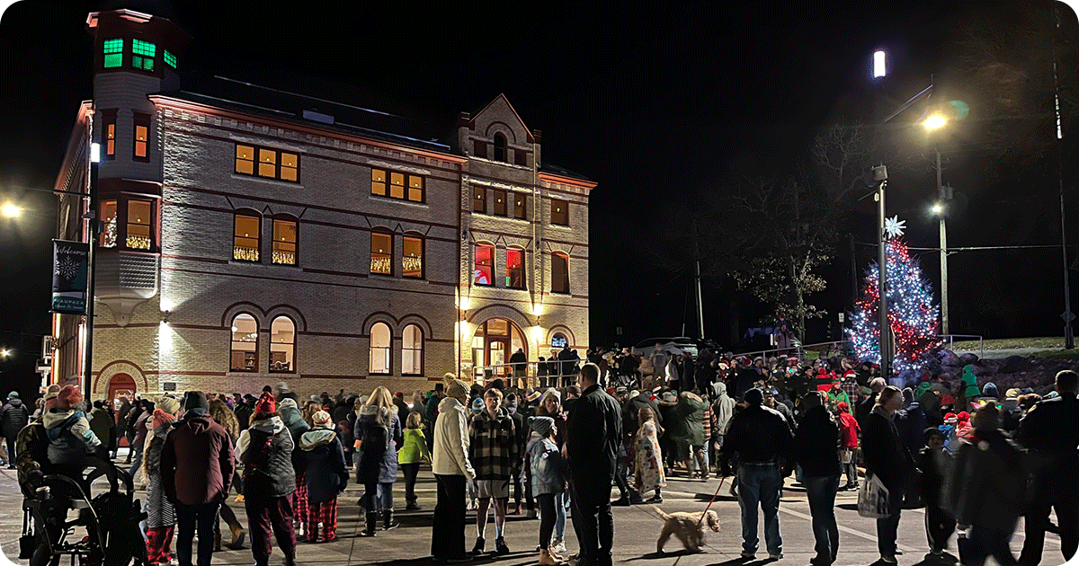 Historic Danes Hall in Waupaca with carolers at Christmas tree lighting.