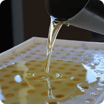 image of liquid lip balm being poured into molds.