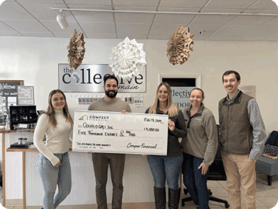 This retail incubator in La Crosse presents a giant check.