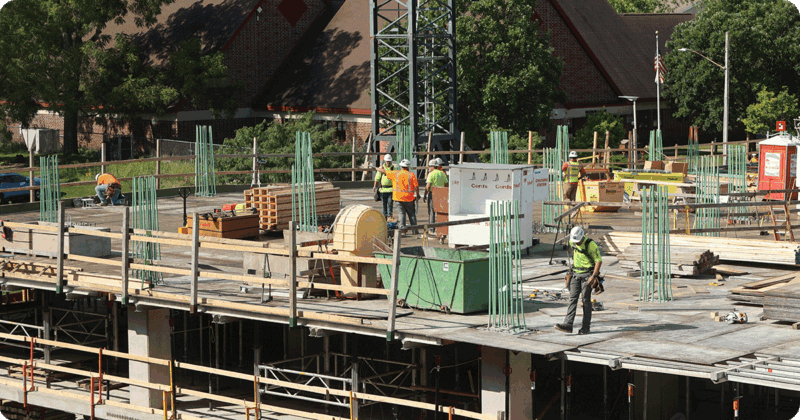 Construction workers pouring concrete for a new building.