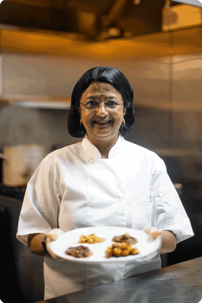 Sara Parthasarathy holding a plate of food.