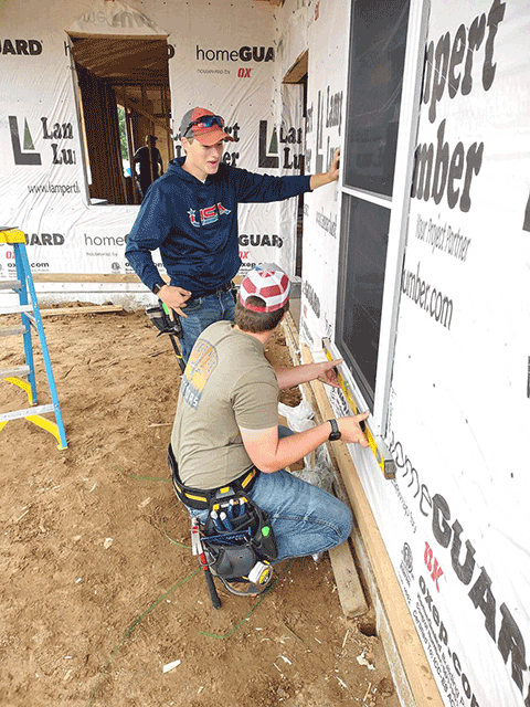 Amery students working on a house.