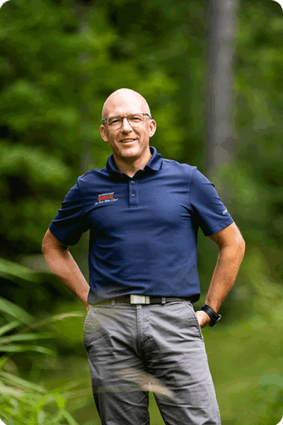 Ben Popp standing in the woods.