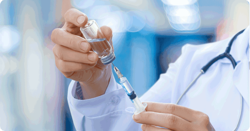 A doctor drawing medicine into a syringe.