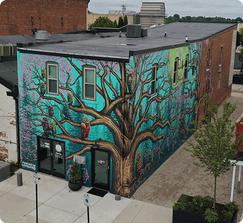 A forest mural painted on a building in DePere, WI