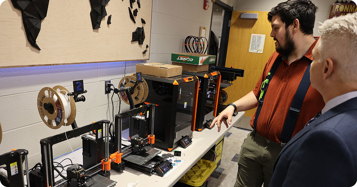 Nicholas Berthelon, 8-12 Tech Education teacher, Belleville High School demonstrates some of the Fab Lab technology to Secretary Miller.