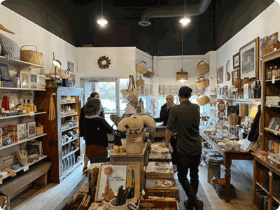 Customers interacting with clerk in a small retail store.