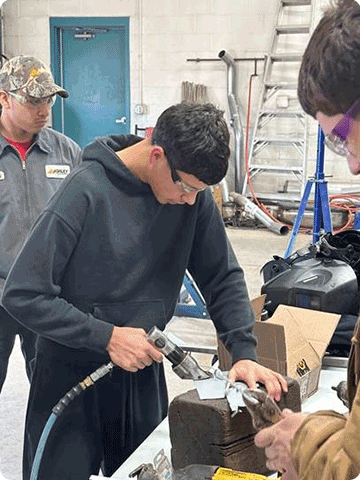 Arcadia High School student using air powered metal shears.