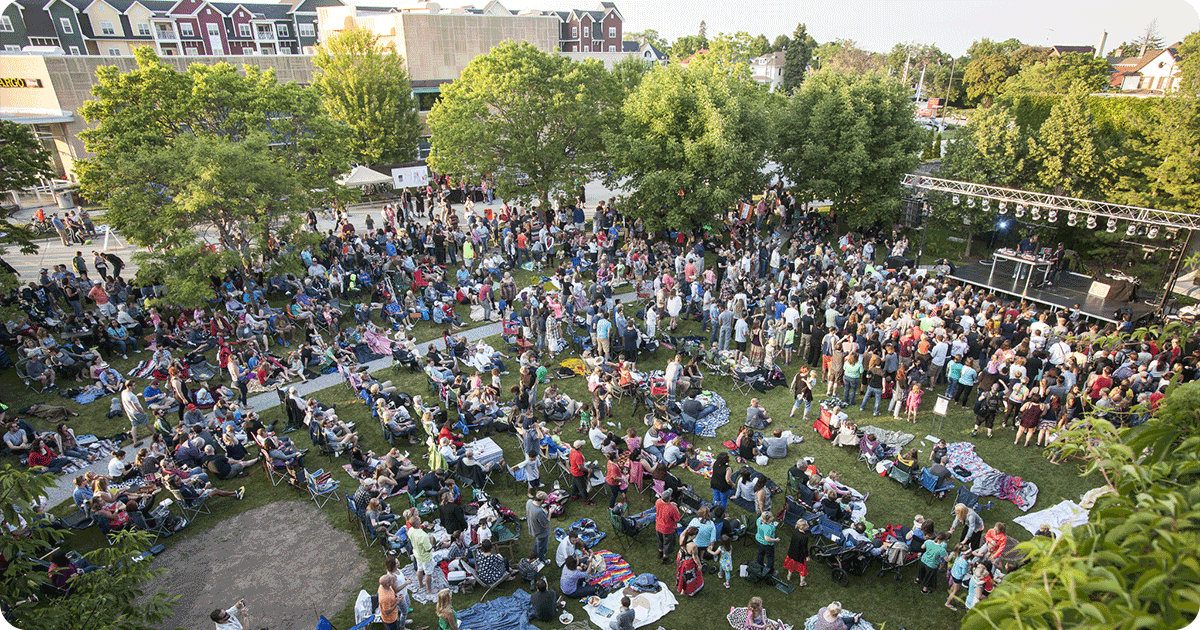 Ariel image of people sitting on the lawn at a Sheboygan outdoor concert.