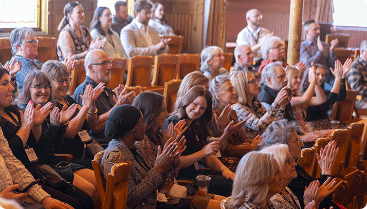 Audience applauding during the Wisconsin Main Street Awards ceremony.